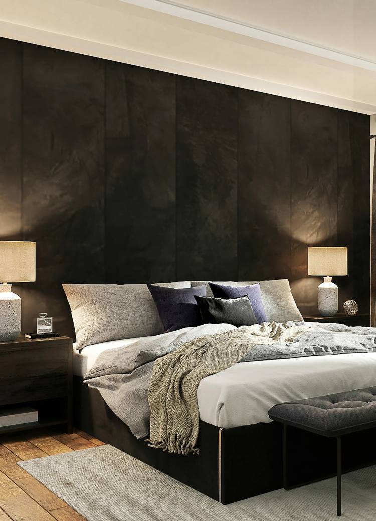 warm toned wood flooring in bedroom with grey area rug and monochromatic black walls and decor,